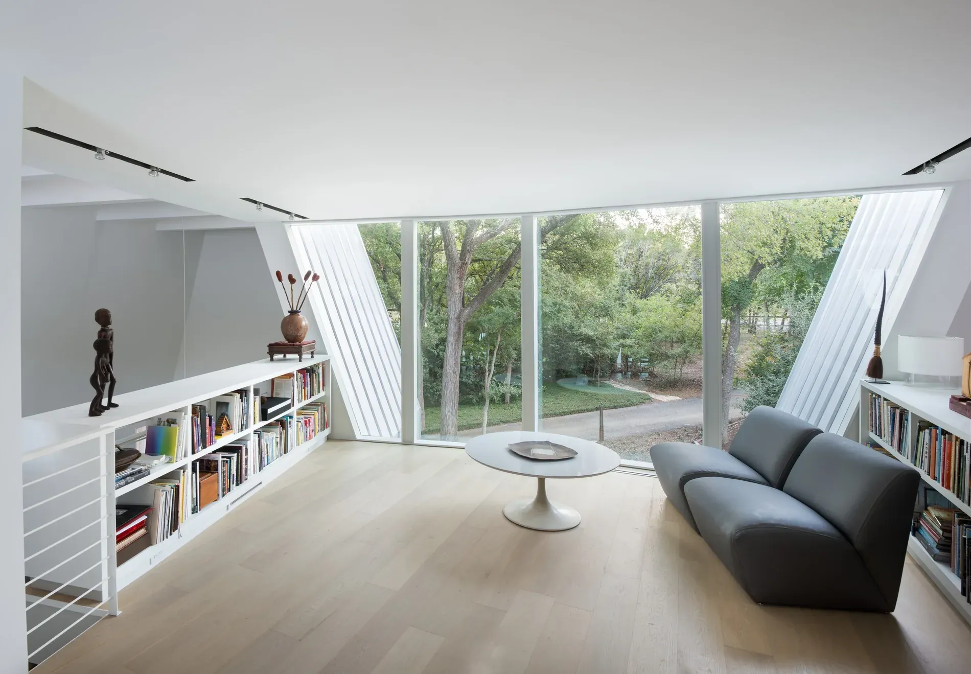 Living room of the award-winning residence, white walls raking to full-height glazing