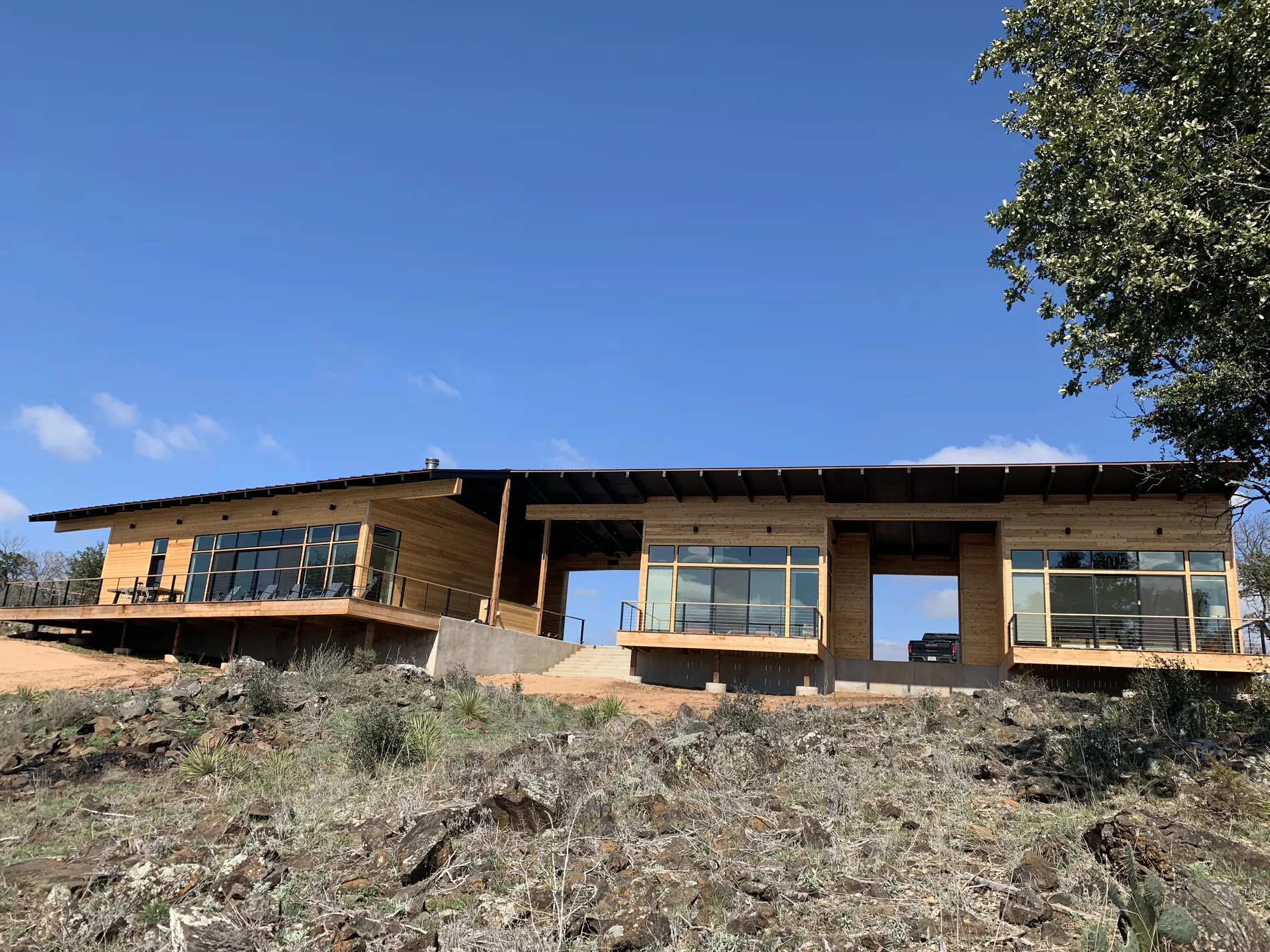 Design/build hunting cabin with a long low roofline and full-height glazing