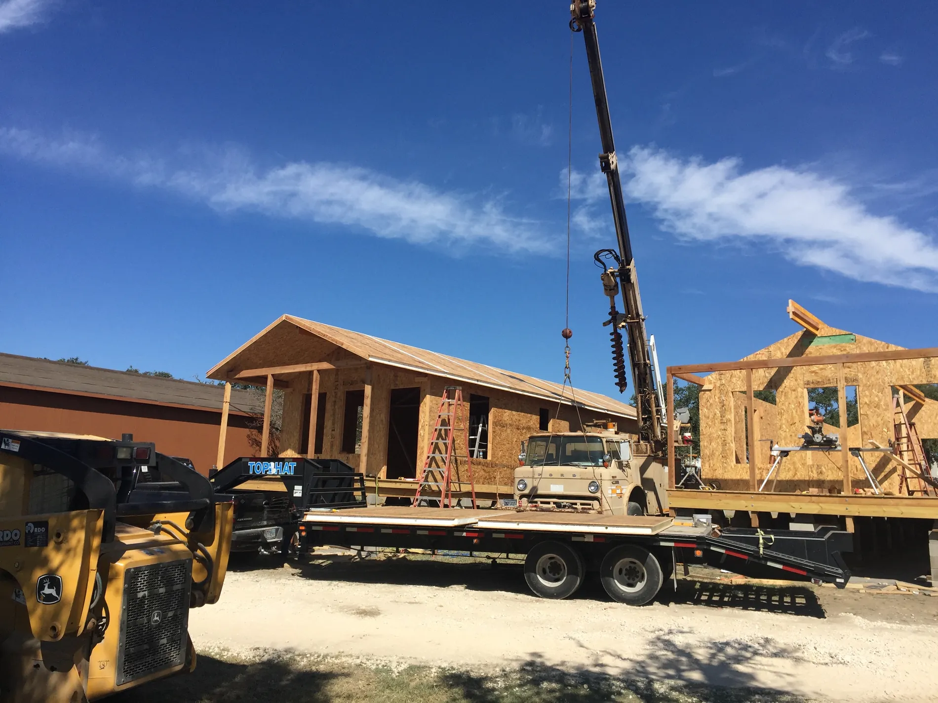 Crane setting a SIP roof panel onto the frame