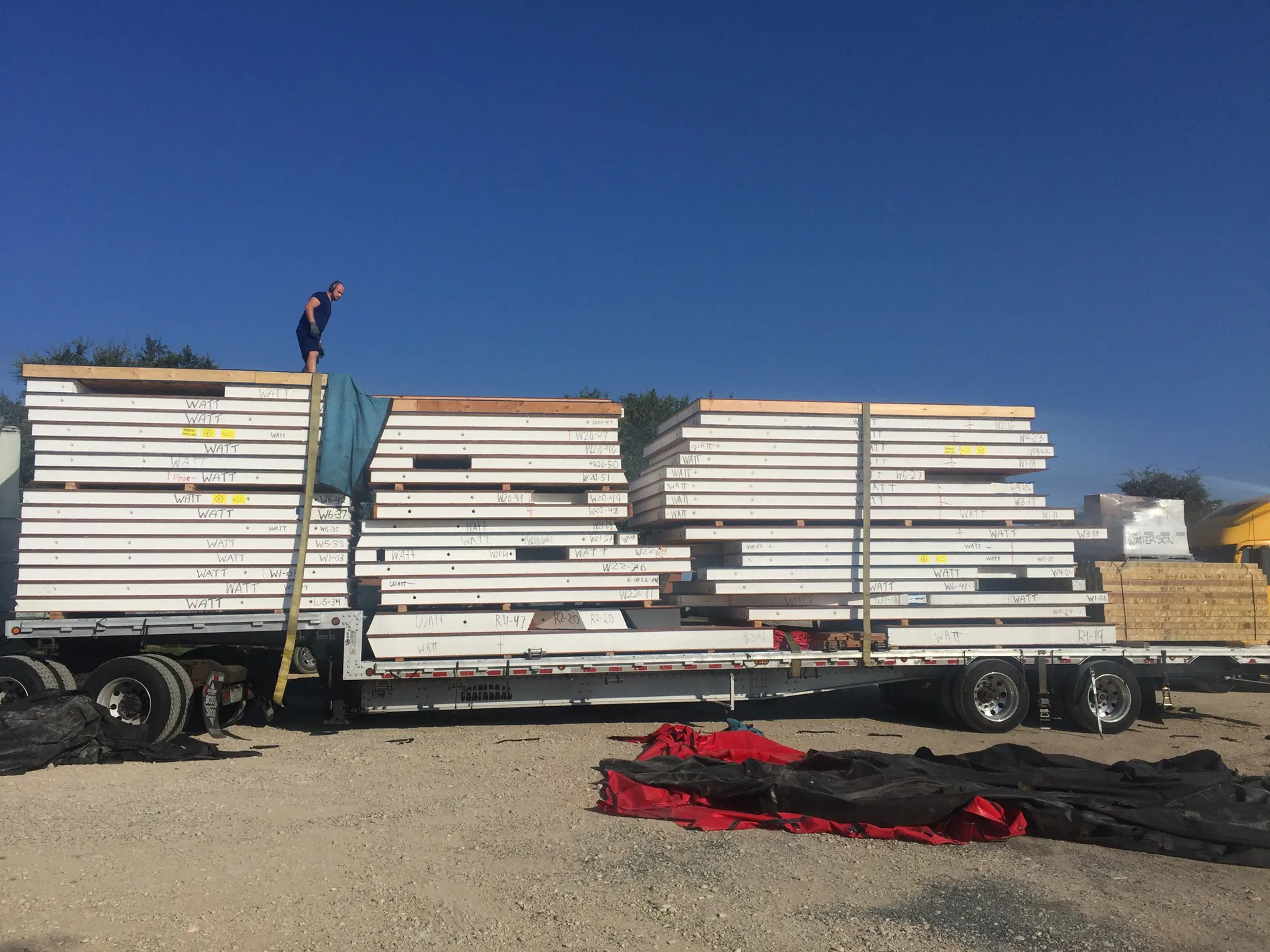 Precut SIP panels stacked and banded on a flatbed trailer ready for delivery